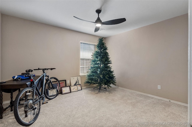 miscellaneous room featuring baseboards, ceiling fan, and carpet