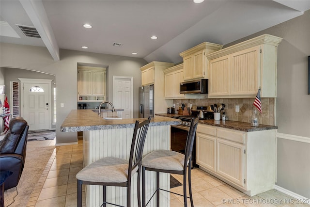 kitchen with light tile patterned floors, decorative backsplash, visible vents, stainless steel appliances, and recessed lighting