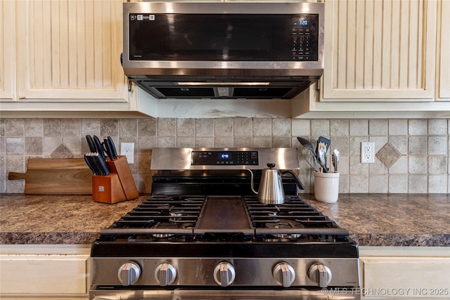 kitchen featuring dark countertops, appliances with stainless steel finishes, and decorative backsplash