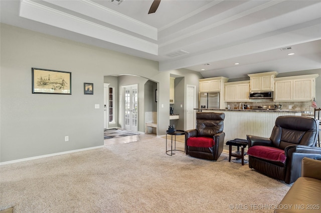 living area with recessed lighting, ceiling fan, light carpet, baseboards, and arched walkways