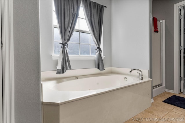 full bath with tile patterned floors, a shower stall, and a bath