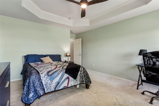 carpeted bedroom featuring baseboards, a raised ceiling, a ceiling fan, and ornamental molding