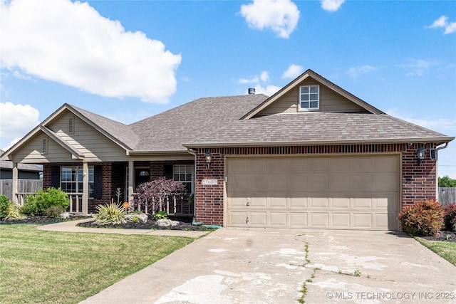 view of front of house with concrete driveway, roof with shingles, a front yard, an attached garage, and brick siding