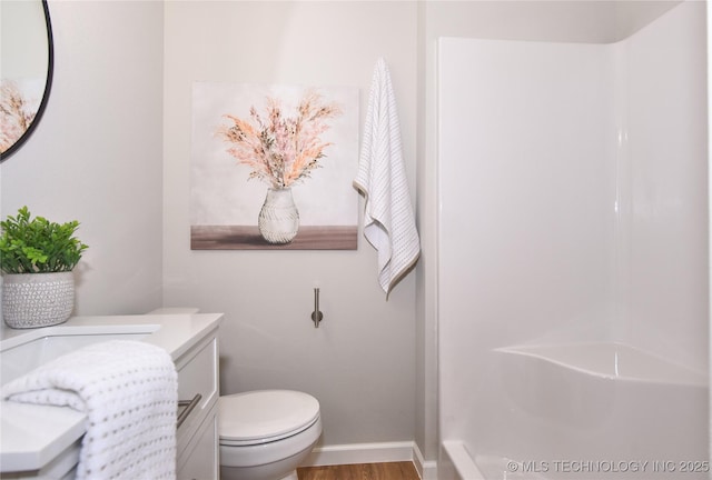 543 N Ridgeway St, Sapulpa, OK 74066 - bathroom featuring a shower, vanity, toilet, wood finished floors, and baseboards