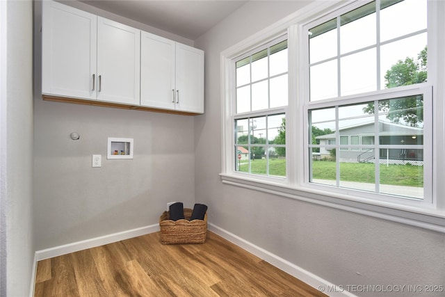 543 N Ridgeway St, Sapulpa, OK 74066 - washroom with cabinet space, baseboards, wood finished floors, and washer hookup