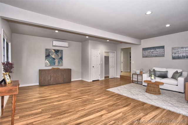 543 N Ridgeway St, Sapulpa, OK 74066 - living area featuring a wall unit AC, recessed lighting, wood finished floors, and baseboards