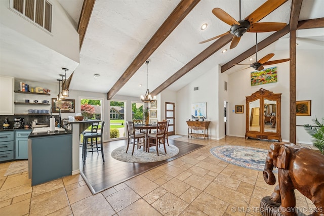 interior space featuring stone tile floors, visible vents, beamed ceiling, and high vaulted ceiling