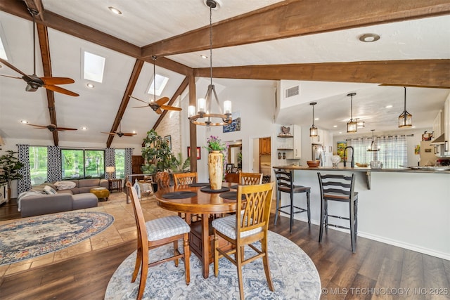 dining area featuring beamed ceiling, visible vents, and a wealth of natural light