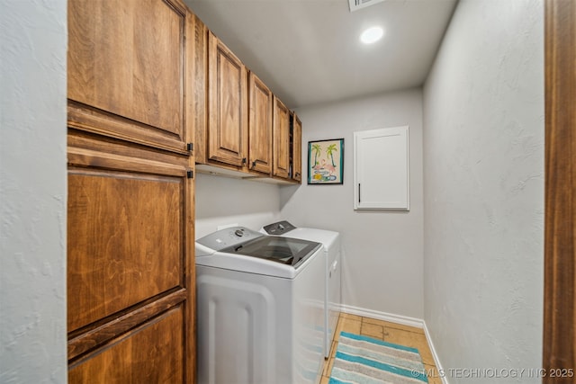 laundry room with independent washer and dryer, cabinet space, tile patterned flooring, and baseboards
