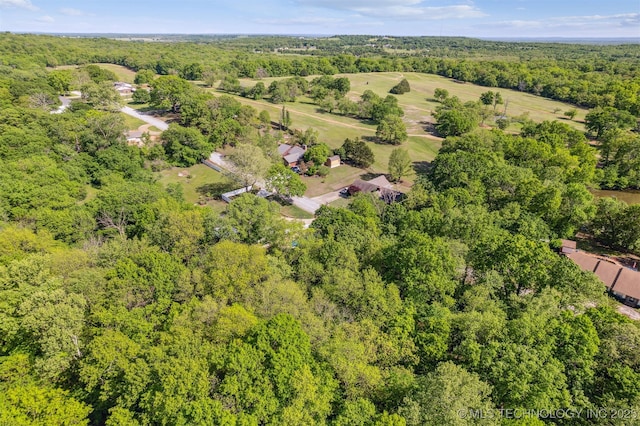 drone / aerial view with a wooded view