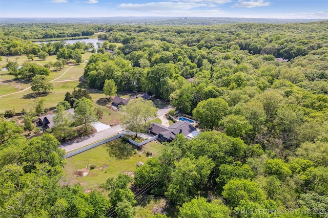 bird's eye view featuring a water view and a forest view