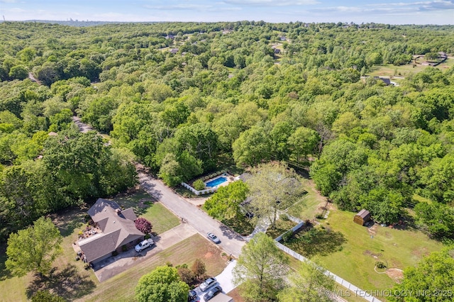 birds eye view of property featuring a wooded view