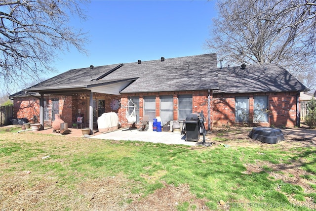3001 Bacon Rd, Muskogee, OK 74403 - back of property with a lawn, a patio area, and brick siding
