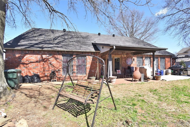 3001 Bacon Rd, Muskogee, OK 74403 - back of house featuring a lawn, a patio area, a shingled roof, and brick siding