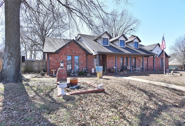 3001 Bacon Rd, Muskogee, OK 74403 - view of front of home featuring fence, roof with shingles, covered porch, and brick siding