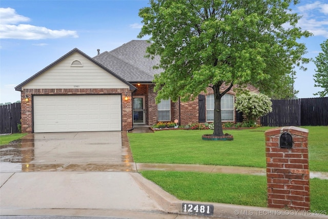 view of front of property with a front lawn, fence, brick siding, concrete driveway, and an attached garage