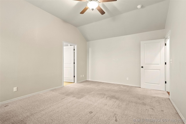 spare room with a ceiling fan, baseboards, light carpet, and lofted ceiling