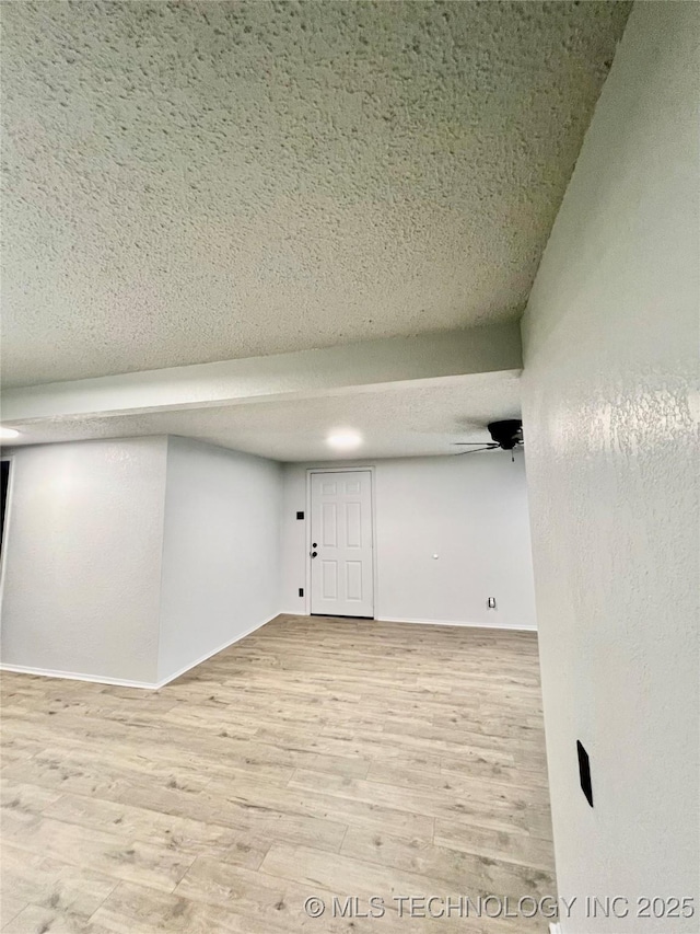 empty room featuring wood finished floors and a textured ceiling