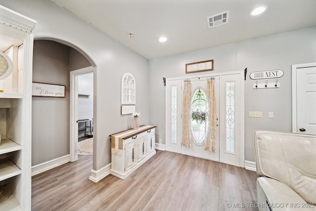 539 N Gunter St, Vinita, OK 74301 - entryway with arched walkways, visible vents, light wood-style flooring, and baseboards