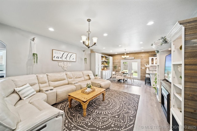 539 N Gunter St, Vinita, OK 74301 - living area featuring an inviting chandelier, wood finished floors, wood walls, and recessed lighting