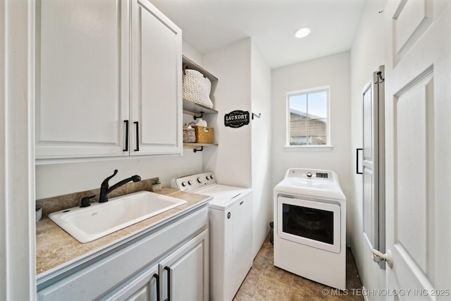 539 N Gunter St, Vinita, OK 74301 - washroom featuring separate washer and dryer, a sink, and cabinet space
