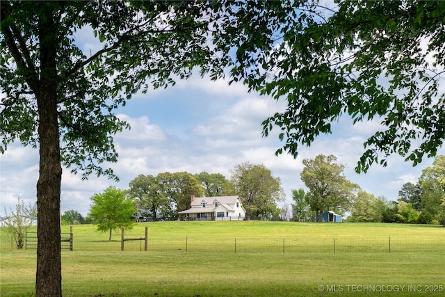 surrounding community featuring fence and a yard