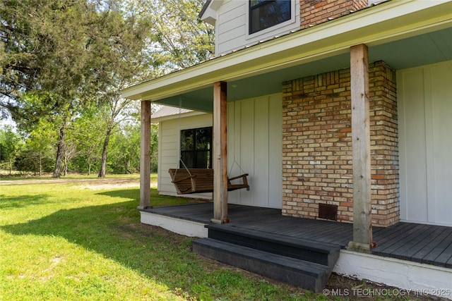 exterior space with brick siding and a yard