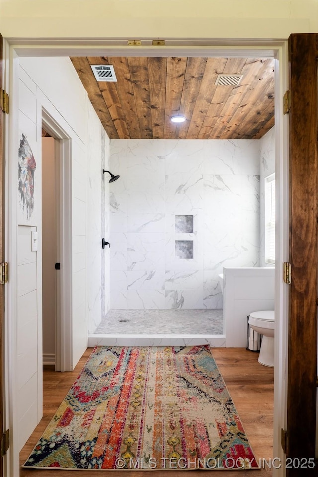 full bathroom with visible vents, wooden ceiling, wood finished floors, and a tile shower