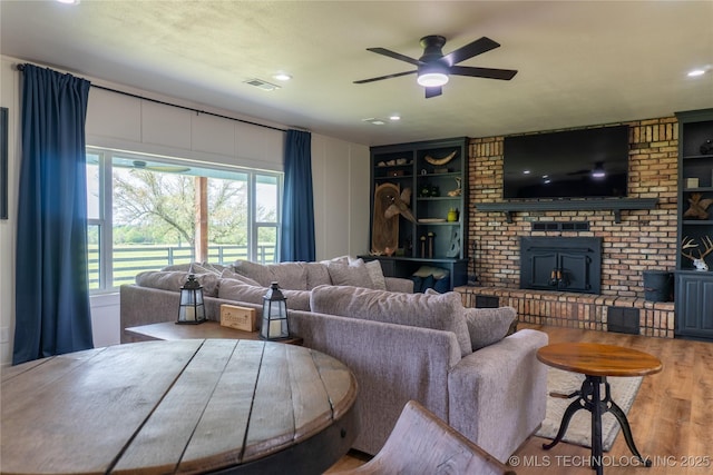 living room featuring wood finished floors, ceiling fan, recessed lighting, and visible vents