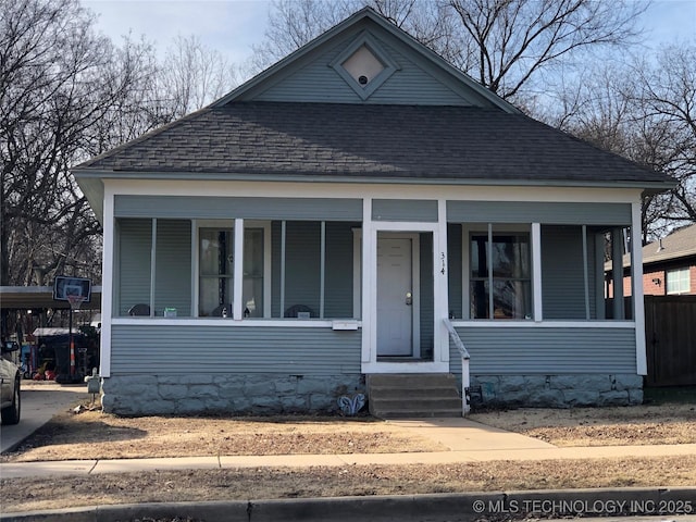 bungalow-style house with roof with shingles and covered porch