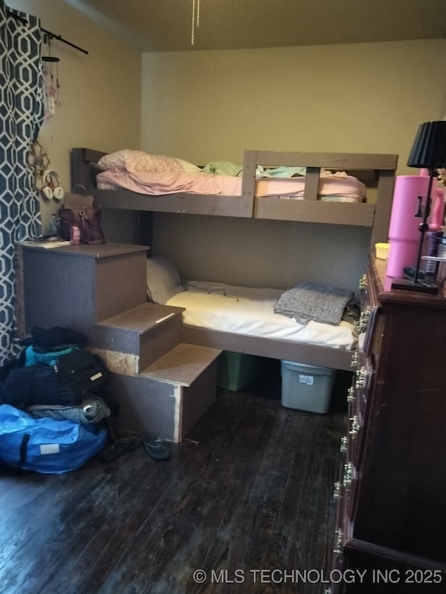 bedroom featuring wood finished floors
