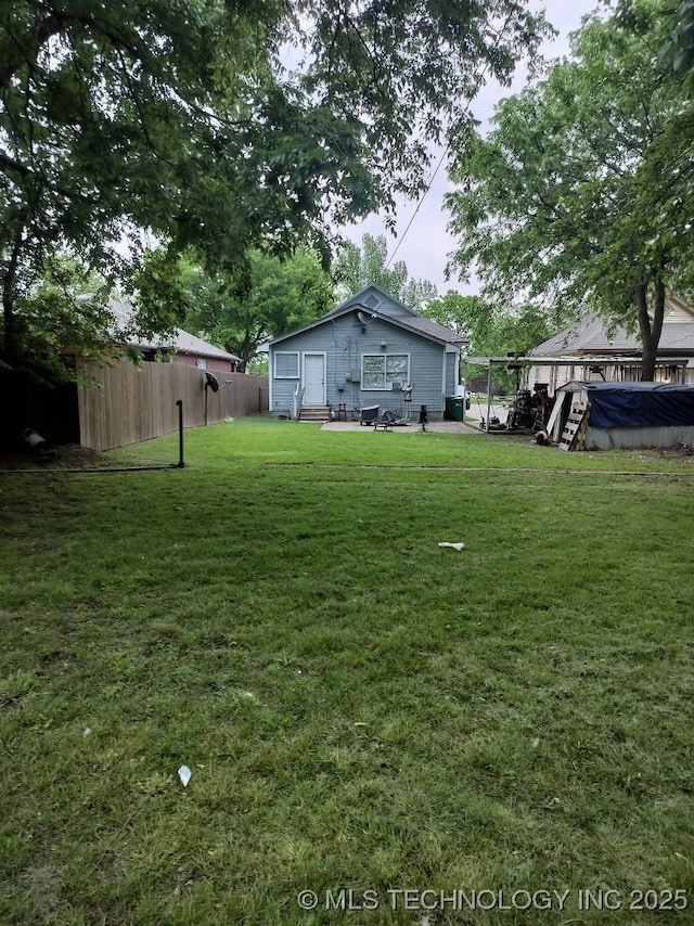 view of yard featuring fence and entry steps