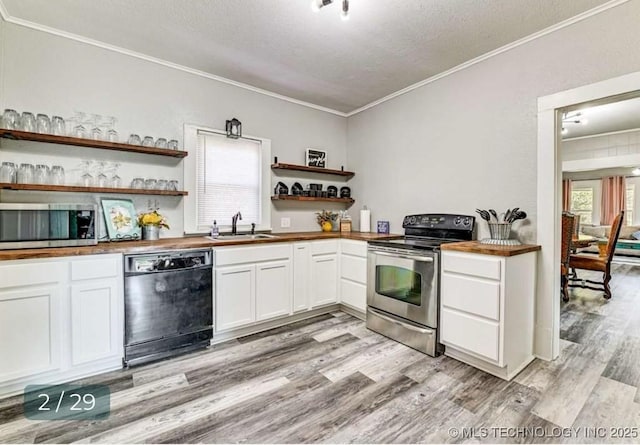 kitchen featuring open shelves, appliances with stainless steel finishes, ornamental molding, a sink, and a textured ceiling