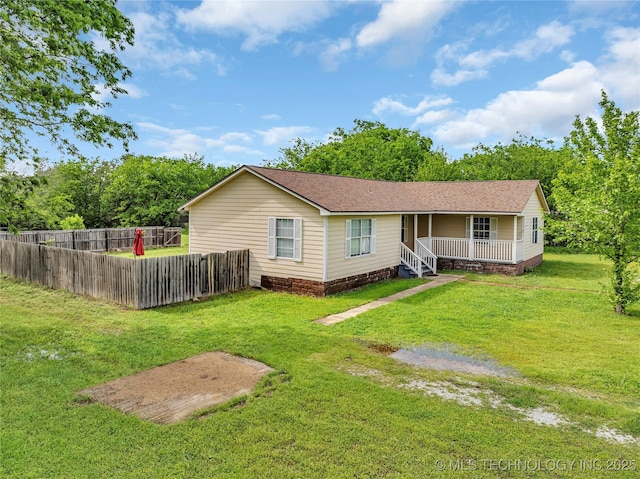 back of house featuring a porch, roof with shingles, a yard, and fence