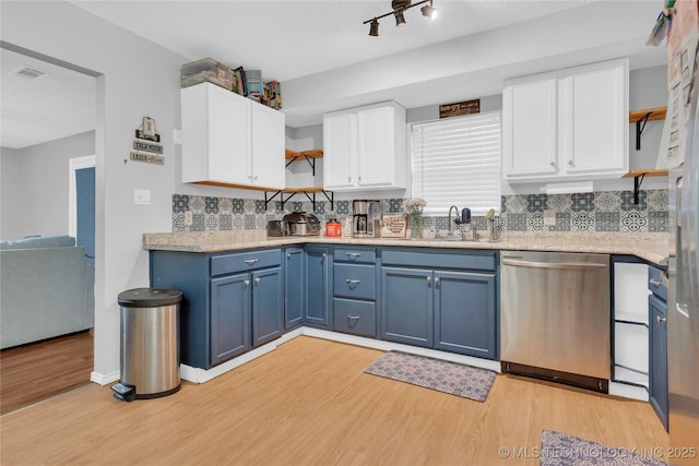 kitchen with open shelves, light wood-style flooring, a sink, blue cabinetry, and dishwasher