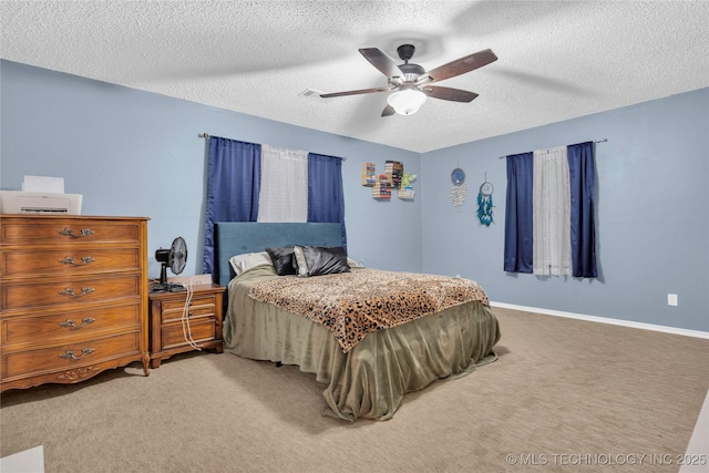 carpeted bedroom featuring ceiling fan and a textured ceiling