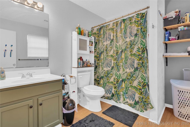 full bath featuring wood finished floors, toilet, a shower with shower curtain, and vanity