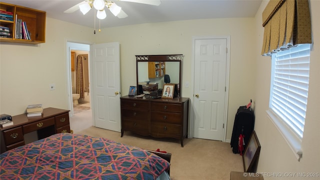 bedroom featuring a ceiling fan and light colored carpet