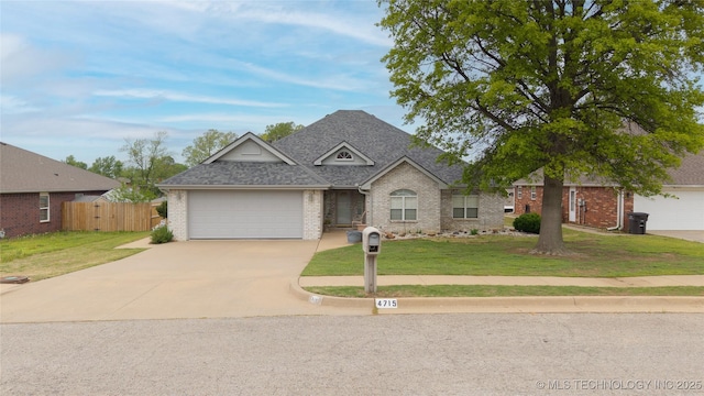 view of front of home featuring brick siding, fence, a garage, a front lawn, and concrete driveway