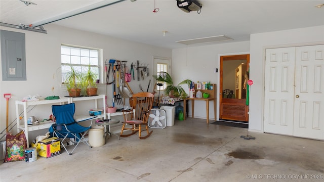 garage with a garage door opener and electric panel