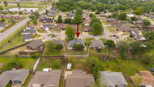 birds eye view of property featuring a water view and a residential view