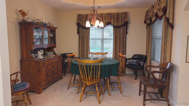 dining space with a notable chandelier, light colored carpet, and visible vents