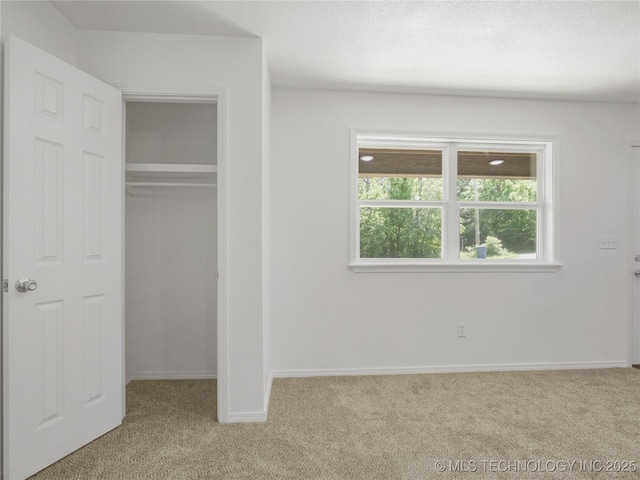 unfurnished bedroom featuring a closet, baseboards, and carpet flooring