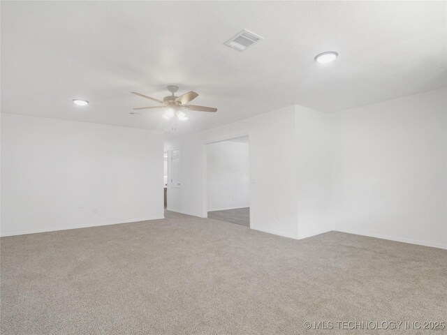 unfurnished room featuring carpet flooring, a ceiling fan, baseboards, and visible vents