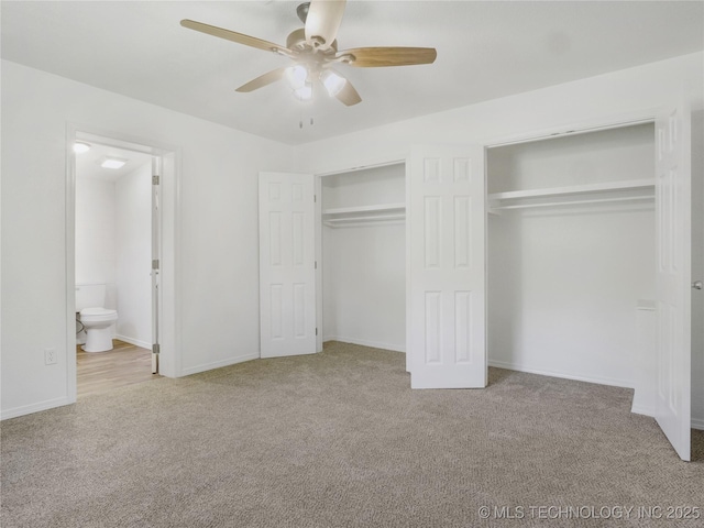unfurnished bedroom featuring a ceiling fan, baseboards, two closets, connected bathroom, and carpet flooring
