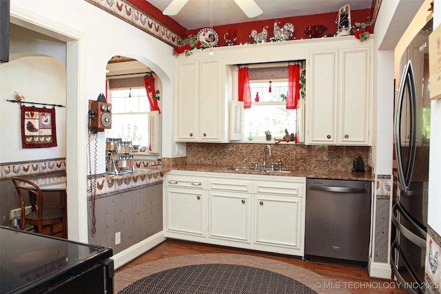 kitchen with white cabinetry, a sink, ceiling fan, black appliances, and dark wood finished floors