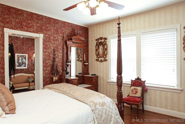 bedroom featuring wood finished floors, wallpapered walls, ornamental molding, baseboards, and a ceiling fan