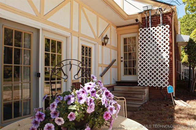entrance to property featuring stucco siding