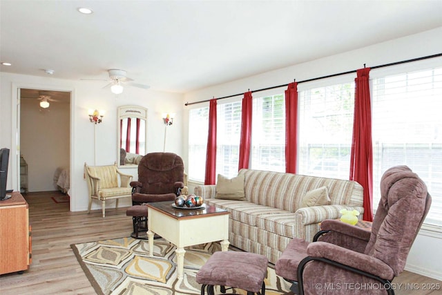 living area with recessed lighting, a ceiling fan, light wood-style floors, and plenty of natural light