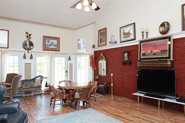 interior space featuring high vaulted ceiling, ceiling fan, and wood finished floors